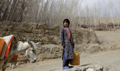 Une jeune fille avec un récipient d'eau vide, en Afghanistan