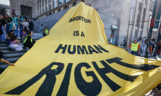 "L'avortement est un droit humain", lit-on sur une banderole déployée à Bruxelles, le 8 mars 2025, à l'occasion de la journée internationale des droits des femmes ( AFP / Simon Wohlfahrt )