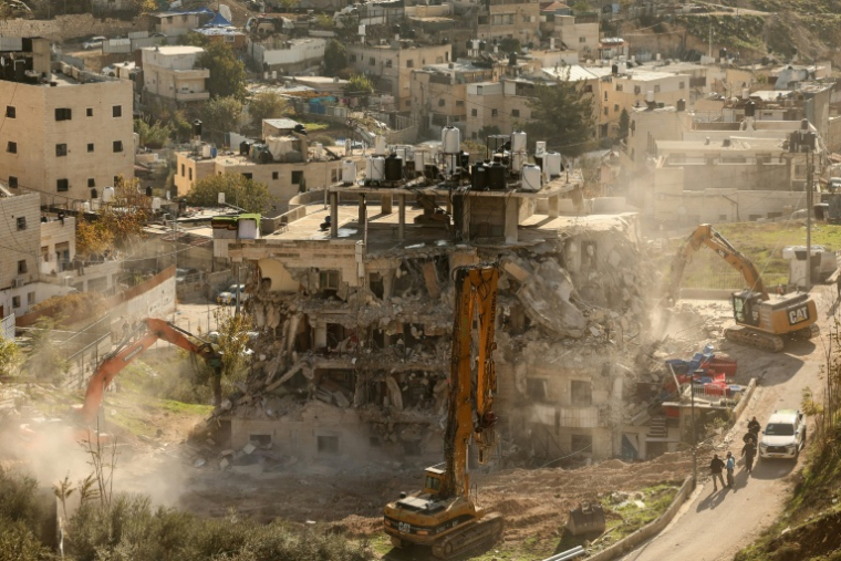 Des bulldozers démolissent un bâtiment dans le quartier de Silwan, le 22 décembre 2025 à Jérusalem-Est ( AFP / AHMAD GHARABLI )