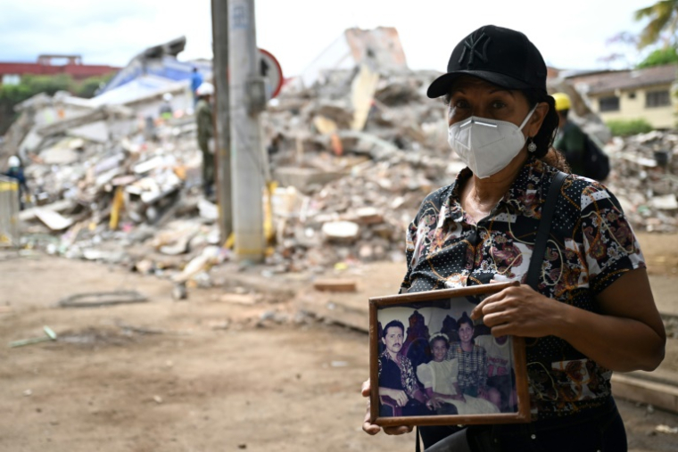 Marlene Niño, qui a perdu sa soeur dans le séisme du 10 août, tient une photo de sa famille retrouvée parmi les objets récupérés dans le complexe résidentiel Torres del Limonar, au sud de Cali, en Colombie, le 16 août 2026 ( AFP / Raul ARBOLEDA )