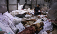 Des corps de Palestiniens tués dans le nord de la bande de Gaza en attendant de l'aide, entreposés à l'hôpital al-Chifa, le 31 juillet 2025 ( AFP / Bashar TALEB )
