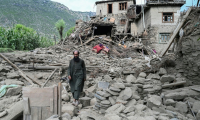 Un homme afghan passe devant une maison endommagée à la suite de tremblements de terre dans le village de Mazar Dara, situé dans le district de Nurgal, dans la province de Kunar, à l'est de l'Afghanistan, le 1er septembre 2025 après un séisme de magnitude 6,0 ( AFP / Wakil Kohsar )