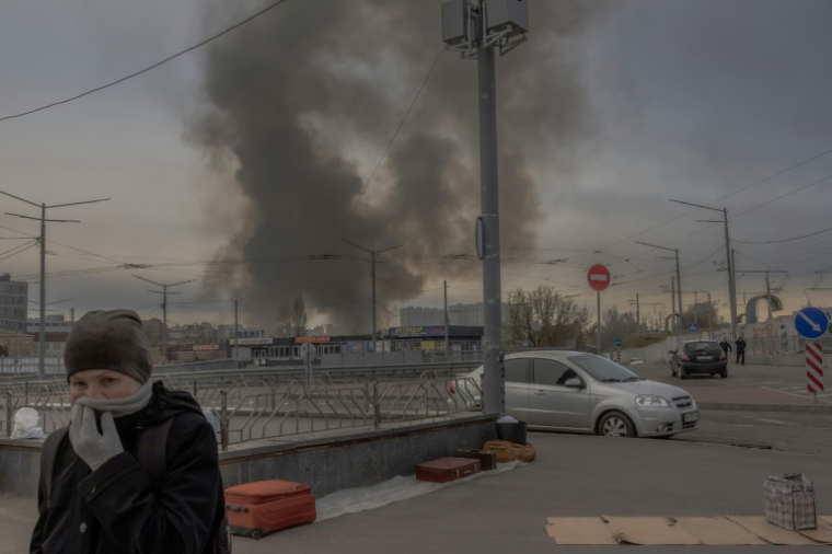Une femme couvre son visage pour se protéger de la fumée après une attaque de missile russe à Kyiv, le 6 avril 2025 en Ukraine (AFP / Roman Pilipey)