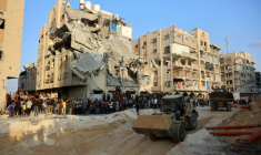 Des Palestiniens regardent une excavatrice à Khan Yunis, dans le sud de la bande de Gaza, le 17 octobre 2025 alors que le Hamas a réaffirmé son engagement à restituer toutes les dépouilles des otages sous les ruines de Gaza ( AFP / Omar AL-QATTAA )