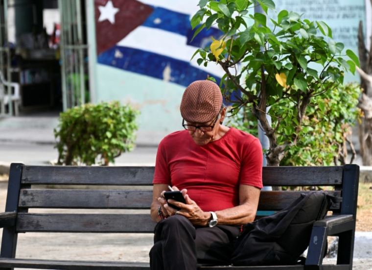Un homme utilise son téléphone portable dans une rue de La Havane, le 3 juin 2025 ( AFP / YAMIL LAGE )