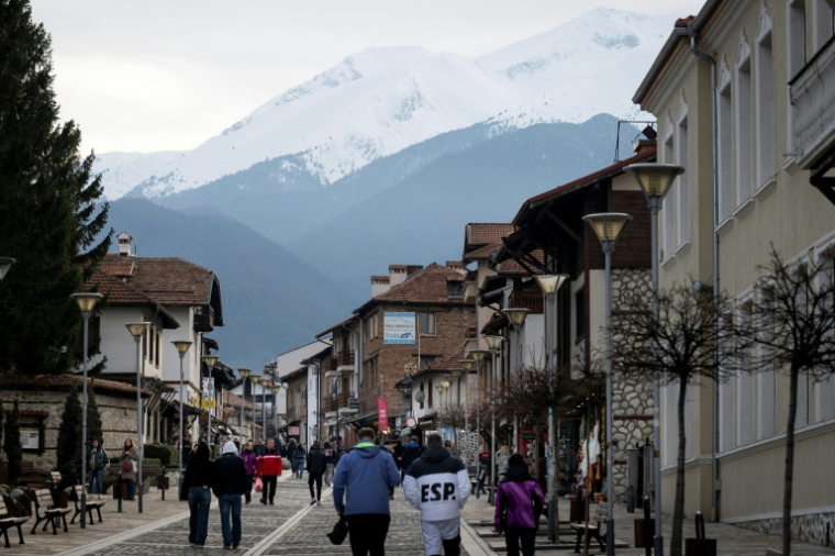 Une rue du centre de Bansko, avec le mont Pirin en arrière-plan, le 14 février 2026 en Bulgarie ( AFP / Nikolay DOYCHINOV )