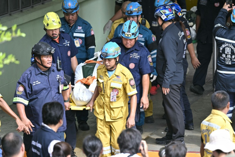 The bodies of school shooting victims are carried out of the school premises in Bang Kruai district, Nonthaburi province, north of the Thai capital Bangkok, on August 7, 2026. A teenager described as "troubled" by a classmate killed his grandparents before gunning down at least six more people at a school in Thailand on August 7, police said. ( AFP / Lillian SUWANRUMPHA )