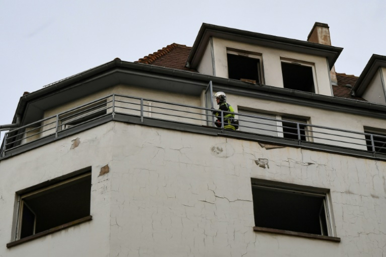 Un pompier inspecte un immeuble endommagé par un incendie, le 27 février 2020 à Strasbourg ( AFP / Patrick HERTZOG )