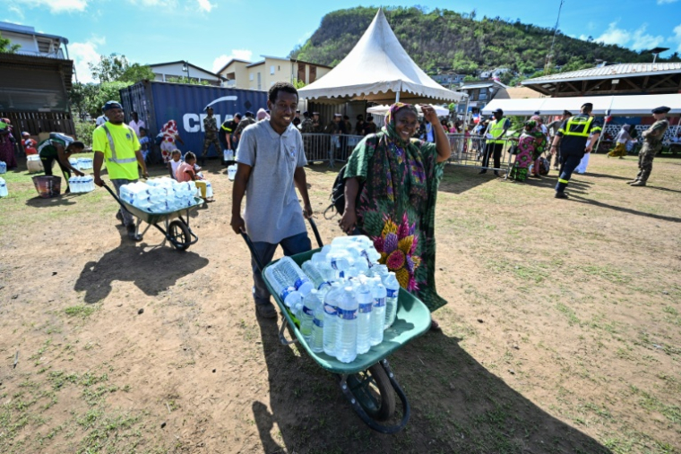Distribution d'eau en bouteille pendant un épisode sévère de sécheresse, le 8 décembre 2023 à Dzaoudzi, à Mayotte ( AFP / MIGUEL MEDINA )