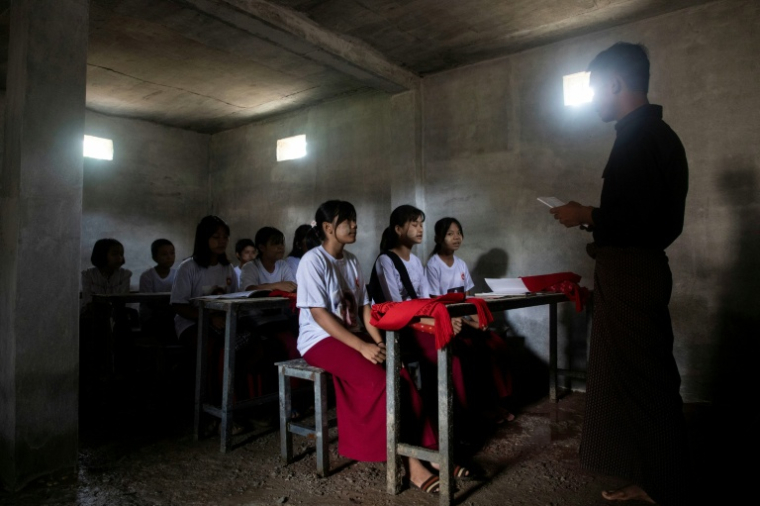 Cette photo prise le 15 août 2025 montre des élèves dans une salle de classe aménagée dans un bunker en béton pour se protéger des frappes aériennes dans un village de la région de Sagaing, en Birmanie. ( AFP / STR )