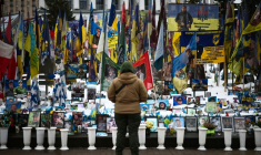 Une personne se tient devant un mémorial de fortune dédié aux soldats ukrainiens et étrangers tombés au combat, sur la place de l’Indépendance à Kiev, le 23 février 2026 ( AFP / HENRY NICHOLLS )