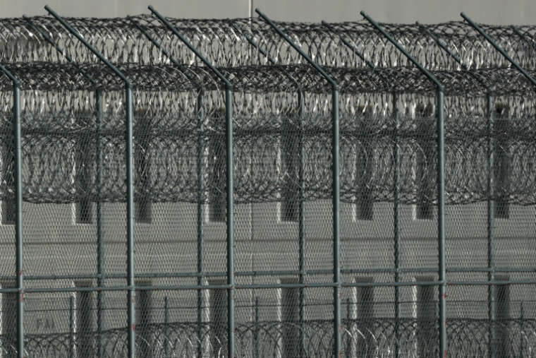 Des barbelés de sécurité entourant le centre opéré par CoreCivic à California City, le 10 juillet 2025 ( AFP / Patrick T. Fallon )