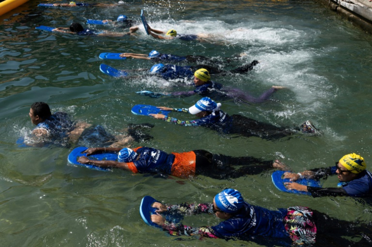 Des mères des quartiers Nord de Marseille participent à un cours de natation dispensé par l'association "Le Grand Bleu" dans une piscine d'eau de mer près du port de l'Estaque, le 11 août 2025 ( AFP / Miguel MEDINA )