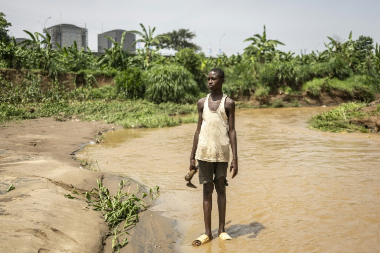 Le jeune travailleur Yacouba Amadou dans une ferme urbaine dans le quartier d'affaires d'Abuja, le 23 mai 2025 au Nigeria ( AFP / OLYMPIA DE MAISMONT )