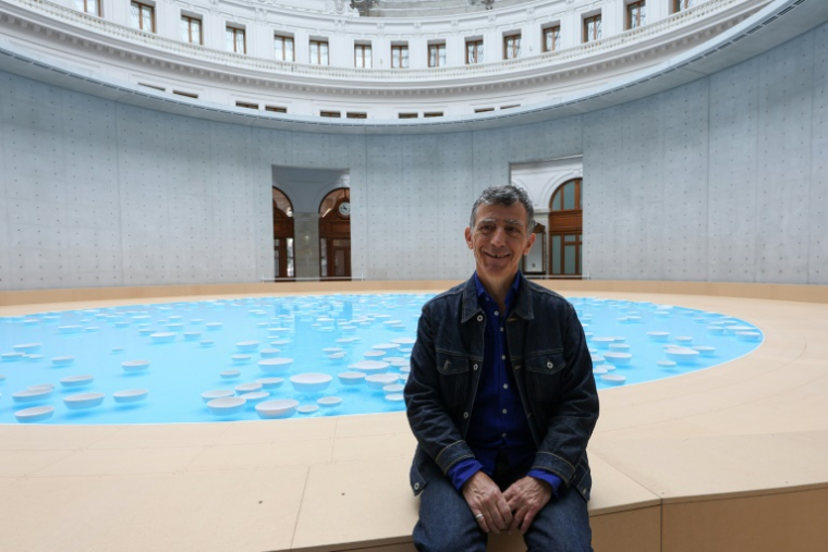 L'artiste français Céleste Boursier-Mougenot pose devant son installation “Clinamen” à la Bourse de Commerce-Pinault Collection à Paris le 5 juin 2025 ( AFP / Xavier GALIANA )