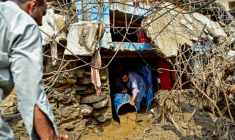 Un homme retire la boue de l'intérieur d'une maison après les crues subites dans la province montagneuse de Khyber Pakhtunkhwa au Pakistan le 16 août 2025 ( AFP / Hasham AHMED )