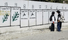 Des jeunes filles passent devant des panneaux pour les élections législatives au Maroc, le 16 septembre 2026 à Tanger ( AFP / Abdel Majid BZIOUAT )