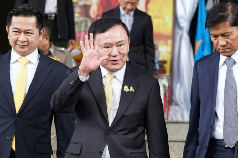 L'ancien Premier ministre thaïlandais Thaksin Shinawatra (c) quitte le tribunal après son acquittement à l'issue de son procès pour crime de lèse-majesté, le 22 août 2025 à Bangkok ( AFP / Chanakarn Laosarakham )