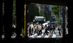Des passants marchent sur un passage piéton à Tokyo