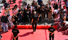 Un employé déroule le tapis rouge devant le Palais des Festivals à Cannes le 12 mai 2026 ( AFP / Antonin THUILLIER )