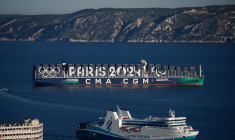 The CMA CGM Greenland container ship is seen at sea with Paris 2024 and the Olympic rings on it during the Olympics torch relay ahead Paris 2024 Olympic games