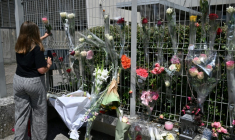 Une élève dépose une fleur sur les grilles du collège Françoise-Dolto à Nogent, au lendemain du meurtre d'une surveillante, le 11 juin 2025 en Haute-Marne ( AFP / FRANCOIS NASCIMBENI )