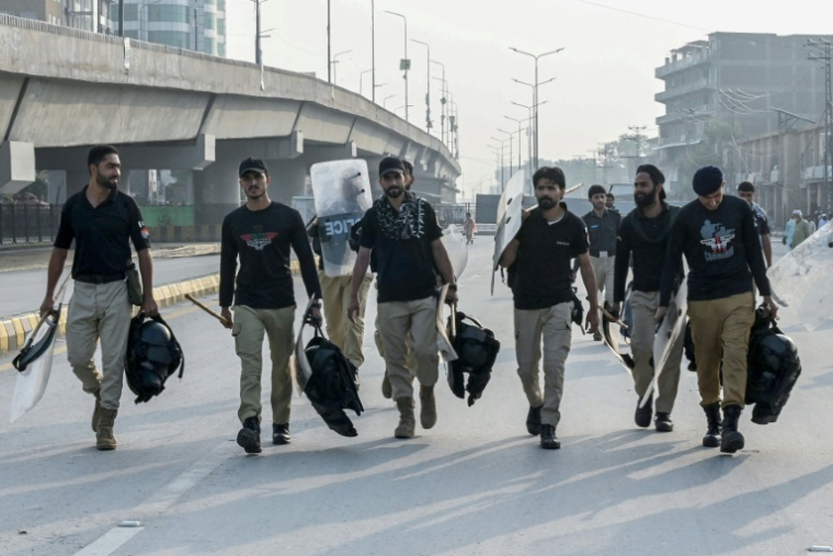Des policiers se dirigent vers leur zone de déploiement dans le contexte des manifestations en cours du parti d’opposition Pakistan Tehreek-e-Insaf (PTI), qui réclame la libération de l’ancien Premier ministre Imran Khan, actuellement emprisonné, à Peshawar, le 11 octobre 2026 ( AFP / Abdul MAJEED )