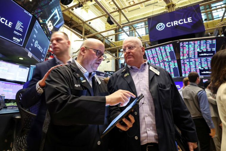 Traders work on the floor of the NYSE in New York
