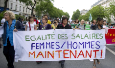 Une femme brandit une banderole où l'on peut lire "Égalité salariale femmes/hommes maintenant" lors d'une manifestation à Paris le 1er mai 2011. ( AFP / MIGUEL MEDINA )