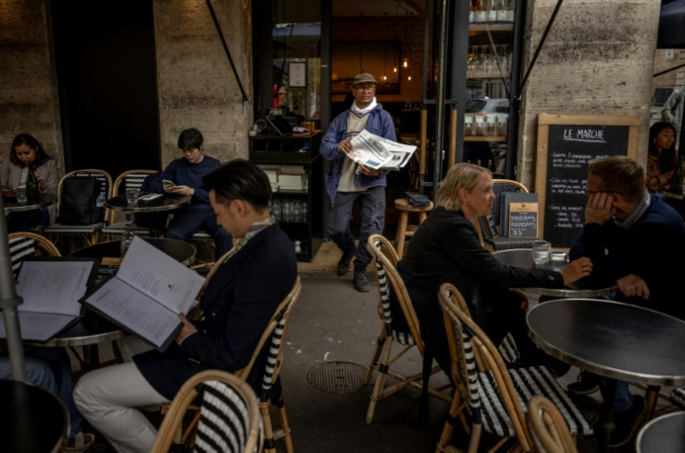 Ali Akbar, vendeur pakistanais de journaux à la criée, dans une rue du Quartier Latin à Paris, le 16 septembre 2025. ( AFP / Guillaume BAPTISTE )