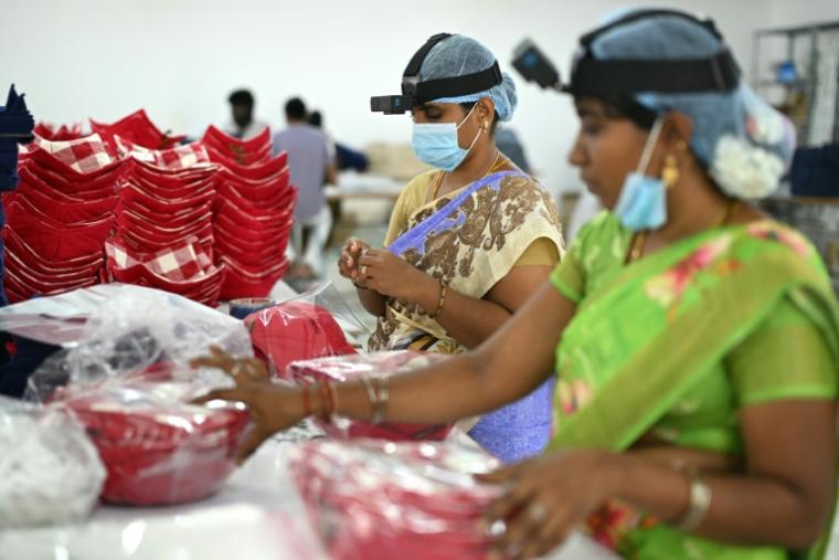 Des employées d'une usine à Karur, en Inde, caméra fixée sur la tête, filment leurs gestes pour entraîner l'IA, le 13 mai 2026  ( AFP / R.Satish BABU )
