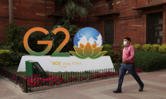 Un homme passe devant une maquette du logo du G20 devant le ministère des finances à New Delhi