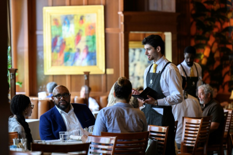 Un serveur prend les commandes au restaurant The Hamilton à Washington le 2 juillet 2025 ( AFP / Drew ANGERER )