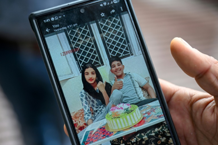 Sarfaraz Mir montre une photo de ses cousins, les jumeaux Zian Khan et Urwa Fatima, tués deux jours avant par un obus pakistanais, le 9 mai 2025 à Poonch, dans le nord-ouest de l'Inde ( AFP / Punit PARANJPE )