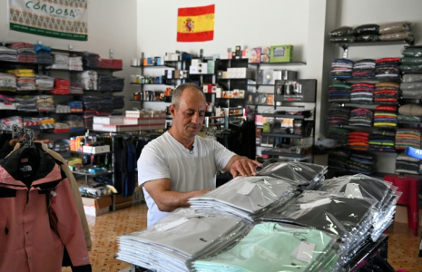 Le commerçant Mark Diab dispose des marchandises dans sa boutique situé près d’une base de la Finul, à Ibl al-Saqi, à la frontière du sud du Liban, le 13 octobre 2026 ( AFP / Joseph EID )