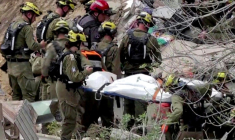 Image extraite d'une vidéo d’AFPTV montrant des équipes de secours israéliennes retirant des corps des décombres d’un immeuble résidentiel détruit par une attaque à missile iranien dans la ville de Haïfa le 6 avril 2026 ( AFPTV / Jorge NOVOMINSKY )