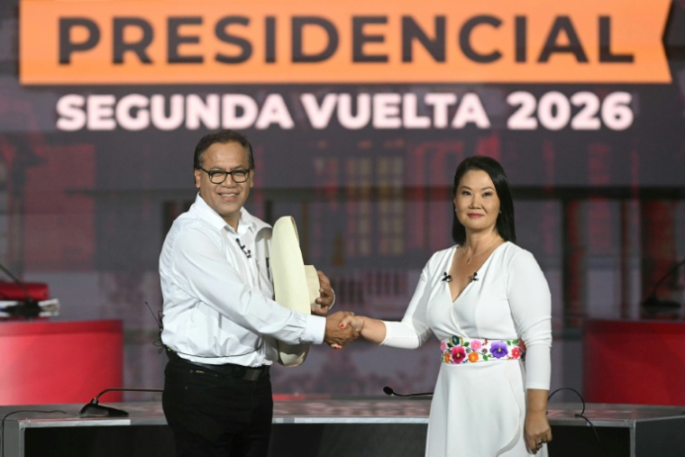 Les candidats à la présidentielle péruvienne, Keiko Fujimori et Roberto Sanchez, se serrent la main lors d'un débat organisé à Lima le 31 mai 2026, avant le second tour du scrutin du 7 juin ( AFP / ERNESTO BENAVIDES )