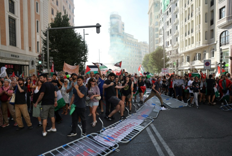 Des manifestants propalestiniens envahissent la rue pendant la 21e et dernière étape du Tour d'Espagne cycliste, le 14 décembre 2025 à Madrid ( AFP / Thomas COEX )