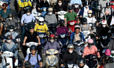 Des conducteurs de deux-roues dans une rue de Hanoi, le 17 juillet 2025  ( AFP / Nhac NGUYEN )