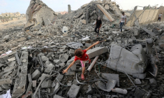 Une fillette palestinienne marche au milieu des décombres d'un bâtiment touché par une frappe israélienne dans le camp de réfugiés de Bureij, dans le centre de la bande de Gaza, le 10 juillet 2025 ( AFP / Eyad BABA )