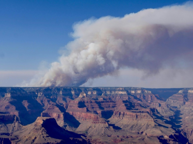 Une photo du Grand Canyon, surplombé par une colonne de fumée à cause d'un incendie, fournie par la direction du parc naturel américain le 11 juillet 2025 ( NATIONAL PARK SERVICE / - )