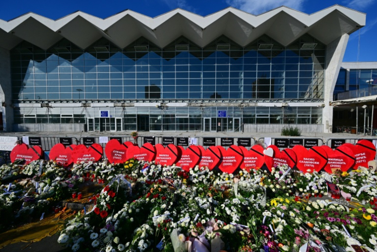 Des fleurs et des pancartes en forme de cœur portant les noms des victimes déposées devant la gare de Novi Sad, en Serbie, le 1er novembre 2025 ( AFP / Andrej ISAKOVIC )