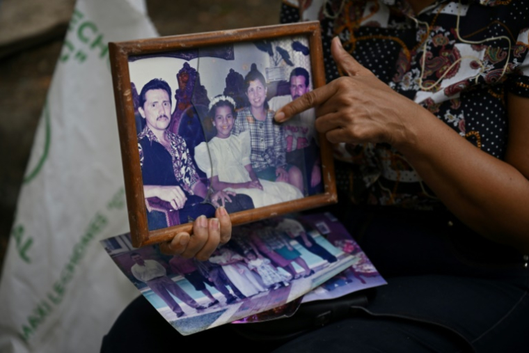 Marlene Niño montre sa sœur, décédée lors du séisme du 10 août, sur une photo de famille retrouvée parmi les objets récupérés dans le complexe résidentiel Torres del Limonar, au sud de Cali, en Colombie, le 16 août 2026 ( AFP / Raul ARBOLEDA )