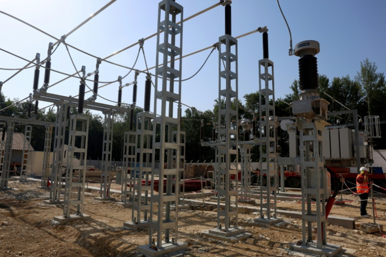 Salarié Enedis travaillant à l'installation d'un nouveau transformateur électrique à Pompignac, dans le département de la Gironde, le 1er juillet 2025.  ( AFP / ROMAIN PERROCHEAU )