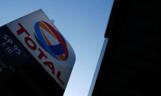 The logo of French oil and gas company Total is seen in a petrol station in Paris