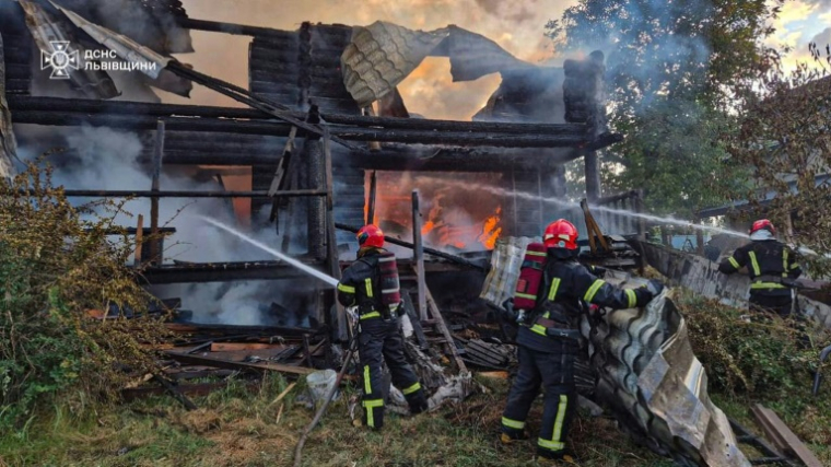 Photo prise par les services d'urgence ukrainiens, et publiée le 21 août 2025, de secouristes ukrainiens luttant contre un incendie après une attaque aérienne russe à Lviv ( Services d'urgence ukrainiens / Handout )