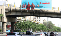 Une affiche anti-américaine sur laquelle est écrit en persan "Nos canons sont pleins" en référence au détroit d'Ormuz, déployée sur un pont au-dessus d'une autoroute à Téhéran, le 12 mai 2026 ( AFP / ATTA KENARE )