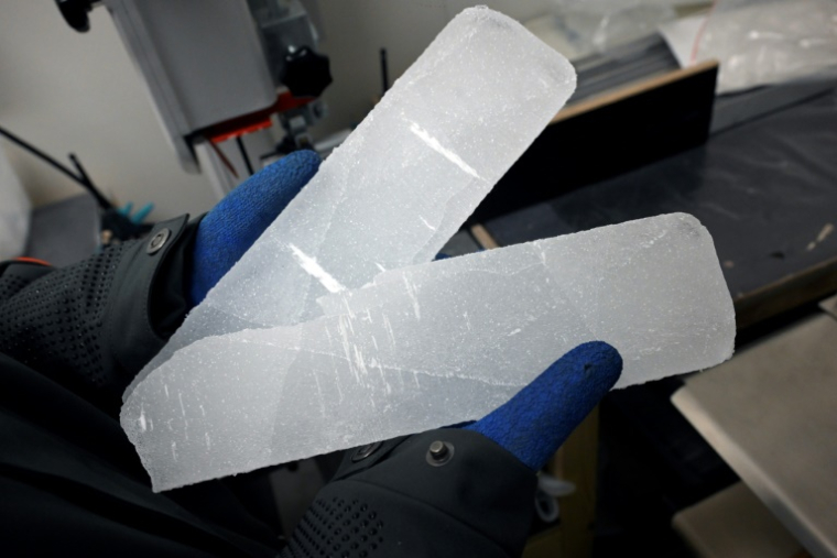 Un scientifique manipule des carottes glaciaires antarctiques dans un laboratoire à Bruxelles, le 15 juillet 2025 en Belgique ( AFP / Nicolas TUCAT )