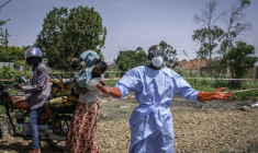 Dieudonné Sezabo, un agent de santé, demande de l'aide pour accueillir une jeune femme soupçonnée d'avoir la maladie Ebola, à l'hôpital de Rwampara, dans le nord-est de la République démocratique du Congo (RDC) le 26 mai 2026 ( AFP / Glody MURHABAZI )