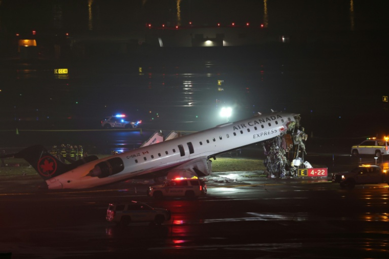 Un CRJ-900 d'Air Canada Express est immobilisé sur la piste après être entré en collision avec un véhicule de l'autorité portuaire, à l'aéroport LaGuardia de New York, le 23 mars 2026 ( AFP / ANGELA WEISS )